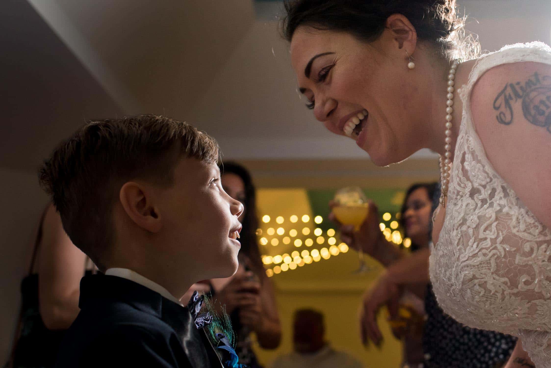 Mother and son smiling during wedding reception