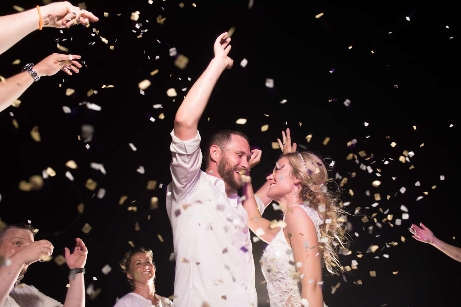 Bride and groom dancing with confetti during wedding reception