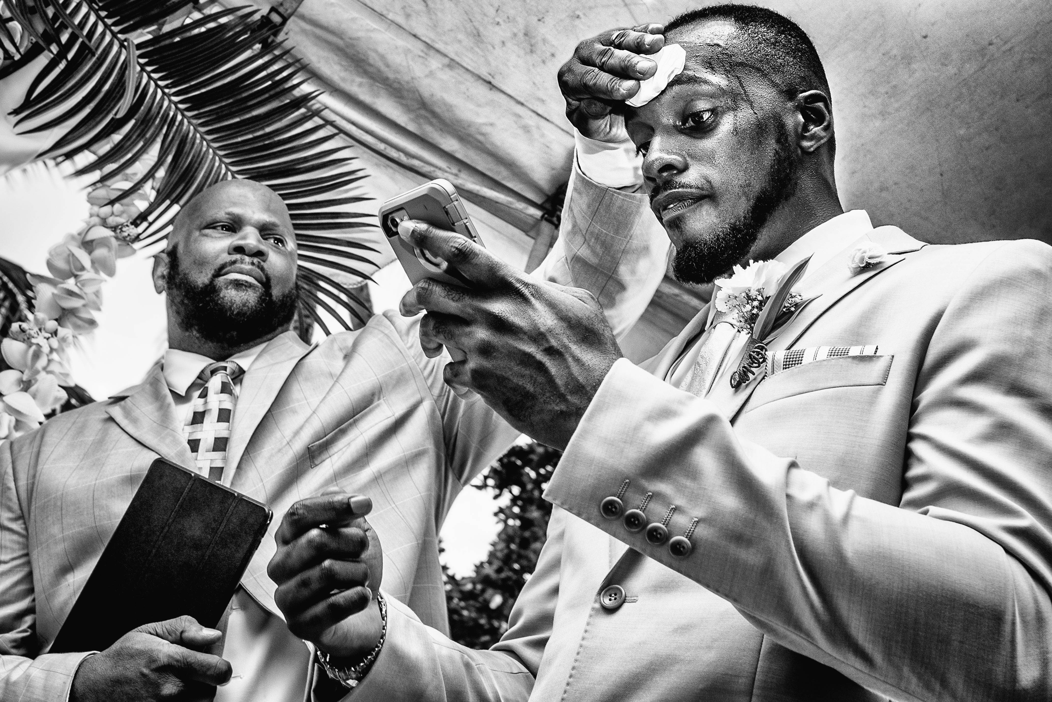Pastor wipes the sweat from the grooms forhead during the ceremony