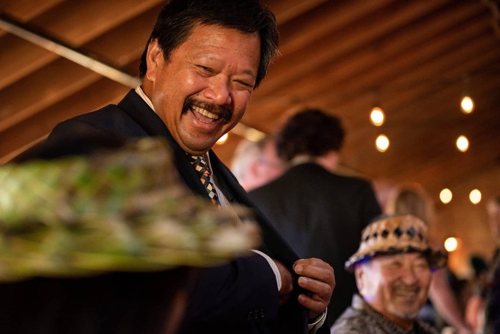 Picture of male wedding guest smiling at a wedding reception
