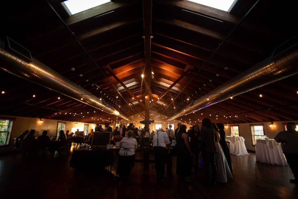 Warm's eye view shot of the venue and the guest mingling and enjoying the reception at The Loft at The Red Building in Astoria, Oregon. 